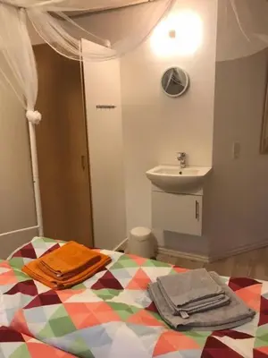a bathroom with a bed with a sink and towels at KristiansBorg in Nykøbing Mors