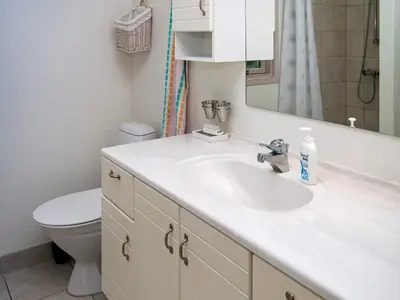 a bathroom with a sink and a toilet and a mirror at 6 person holiday home in Hurup Thy in Sønder Ydby
