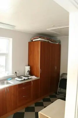 a kitchen with a sink and a cupboard at Hellerup Bed & Breakfast in Løgstrup