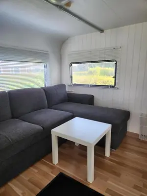 a living room with a couch and a table at Løgstør Camping in Løgstør