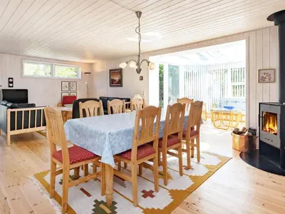 a dining room with a table and chairs and a fireplace at 6 person holiday home in Højslev-By Traum in Højslev