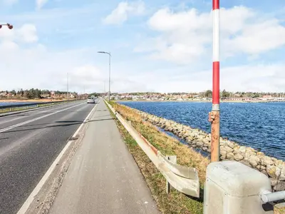 a road next to a body of water at 6 person holiday home in Højslev-By Traum in Højslev