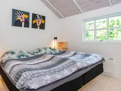 a bedroom with a bed and two paintings on the wall at 6 person holiday home in Højslev-By Traum in Højslev
