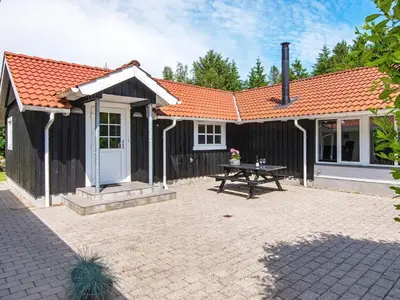 a house with a picnic table in front of it at 6 person holiday home in Højslev-By Traum in Højslev