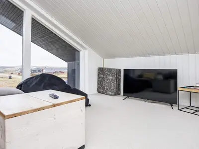 a living room with a couch and a large screen tv at 10 person holiday home in Harboøre-By Traum in Harboør