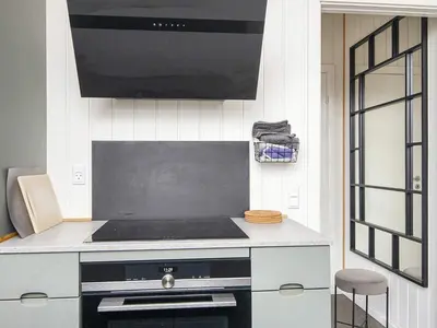 a kitchen with a stove and a microwave at 10 person holiday home in Harboøre-By Traum in Harboør