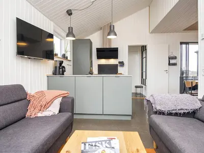 a living room with a couch and a kitchen at 10 person holiday home in Harboøre-By Traum in Harboør
