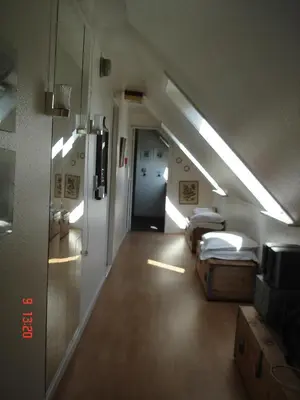 a room with two beds and a hallway with lights at Munkebo B&B, Thy in Thisted