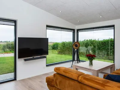 a living room with a couch and a flat screen tv at 10 person holiday home in Vinderup-By Traum in Vinderup