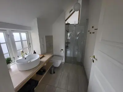 a white bathroom with a sink and a toilet at Fiskerhuset in Agger
