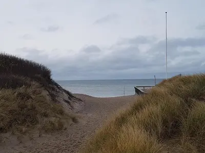 a dirt path leading to the ocean on a beach at Fiskerhuset in Agger