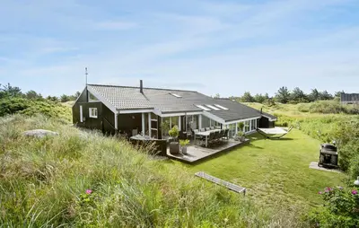 a black house in the middle of a field at 4 Bedroom Nice Home In Saltum in Saltum
