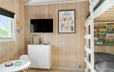 a bedroom with a bunk bed and a tv on a wall at 4 Bedroom Nice Home In Saltum in Saltum
