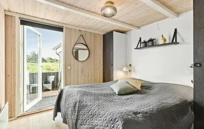 a bedroom with a bed and a large window at 4 Bedroom Nice Home In Saltum in Saltum