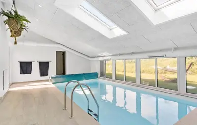 a swimming pool with a ceiling with skylights at 4 Bedroom Nice Home In Saltum in Saltum