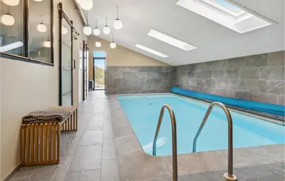a swimming pool in a building with a tile floor at Nice Home In Saltum With Kitchen in Saltum