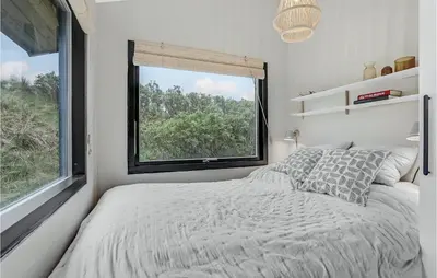 a bedroom with a bed and a large window at Nice Home In Saltum With Kitchen in Saltum