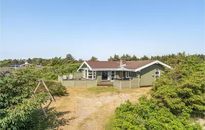 a house on a hill with a yard at Holiday Home Porsevej Saltum in Saltum