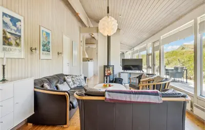 a living room with a couch and a table at Pet Friendly Home In Pandrup With Sauna in Pandrup