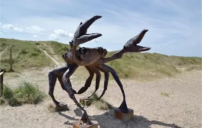 a statue of a crab standing in the sand at Holiday Home Østersvej Fjerritslev Xii in Fjerritslev