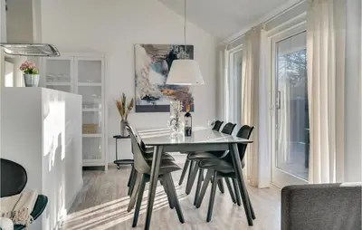 a dining room with a table and chairs at Holiday Home Kronvildtvej Brovst Ii in Brovst