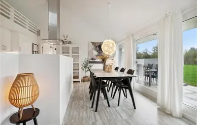a dining room with a table and chairs at Holiday Home Kronvildtvej Brovst Ii in Brovst