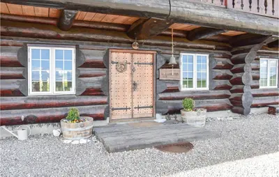 a wooden cabin with a door and two potted plants at 9 Bedroom Beautiful Home In Lemvig in Lemvig
