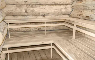 an empty wooden sauna with a stone wall at 9 Bedroom Beautiful Home In Lemvig in Lemvig