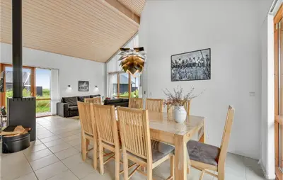 a dining room with a table and chairs at Holiday Home Klitengene Ulfborg Vi in Ulfborg