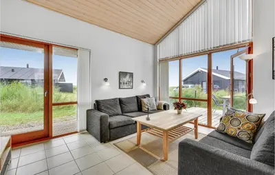 a living room with a couch and a table at Holiday Home Klitengene Ulfborg Vi in Ulfborg