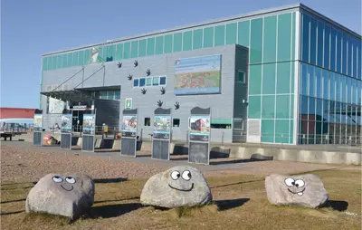 a building with three large rocks with faces on it at Holiday Home Bjergehusvej in Harboør