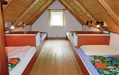 a room with three beds in a attic at Humlebo in Vemb