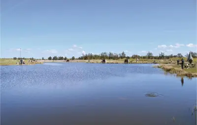 a large body of water with people standing around it at Humlebo in Vemb