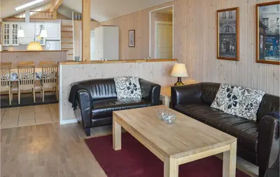 a living room with two leather couches and a coffee table at Frk Lyng in Harboør