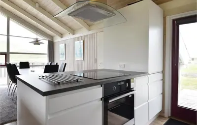 a kitchen with a stove and a counter top at Holiday Home Arcticvej Harboøre Iv in Harboør