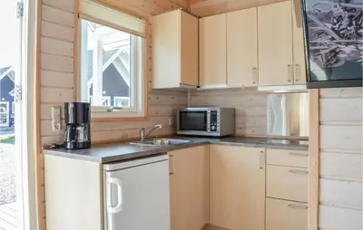 a kitchen with a sink and a microwave at Hytte 6 in Thyborøn
