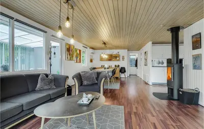 a living room with a couch and a table at Fjordglimt in Vestervig