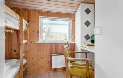 a room with a desk and a chair in a room at Holiday Home Kristinesvej Xii in Thisted