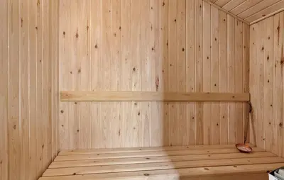 a wooden interior of a sauna with wooden shelves at Holiday Home Kristinesvej Xii in Thisted