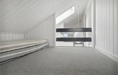 a white room with a bed and a staircase at Stunning Home In Thisted With Sauna in Thisted