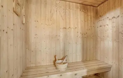a wooden sauna with a cat in a bucket at Stunning Home In Thisted With Sauna in Thisted