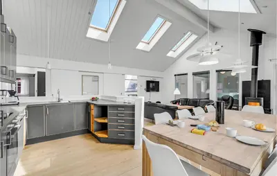 a kitchen and living room with a dining room and a table at Stunning Home In Thisted With Sauna in Thisted