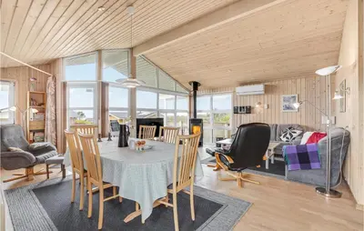 a dining room and living room with a table and chairs at Holiday Home Hannesvej V in Vestervig