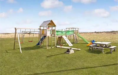 a playground with a slide and a picnic table at Amazing Home In Thisted With Sauna in Thisted