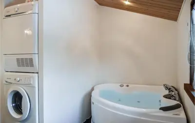 a small bathroom with a washing machine and a washer and dryer at Holiday Home Hellesvej Vestervig Denm in Vestervig