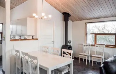 a kitchen and dining room with a white table and chairs at Holiday Home Hellesvej Vestervig Denm in Vestervig