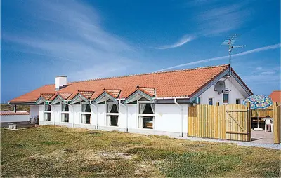 a large white building with a red roof at Holiday Home Klitstien Ii in Thisted