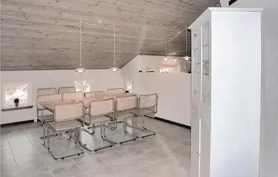 a dining room with a table and chairs at Holiday Home Klitstien Ii in Thisted