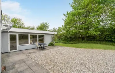 a patio with a table in front of a house at Holiday Home Årup Byvej in Snedsted
