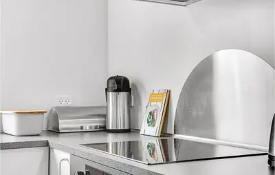a kitchen counter with a sink and a coffee maker at Holiday Home Årup Byvej in Snedsted